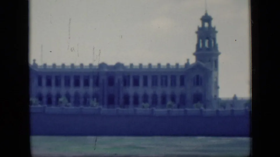 1946 Cairo footage showing a large ornate riverside building with a tower and arched window details.
