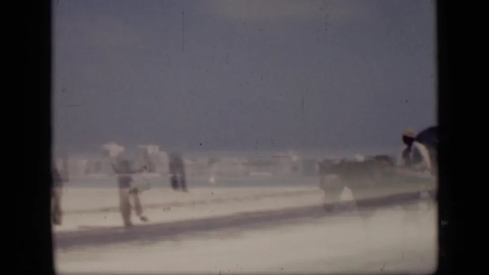 1946 Cairo roadside scene with a donkey and rider moving along the waterfront road, partly blurred by motion and faded film exposure.