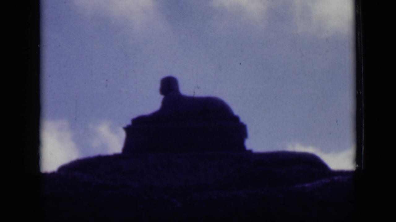 The 1946 Cairo clip holds on a distant statue-like silhouette on elevated ground with clouds behind it.