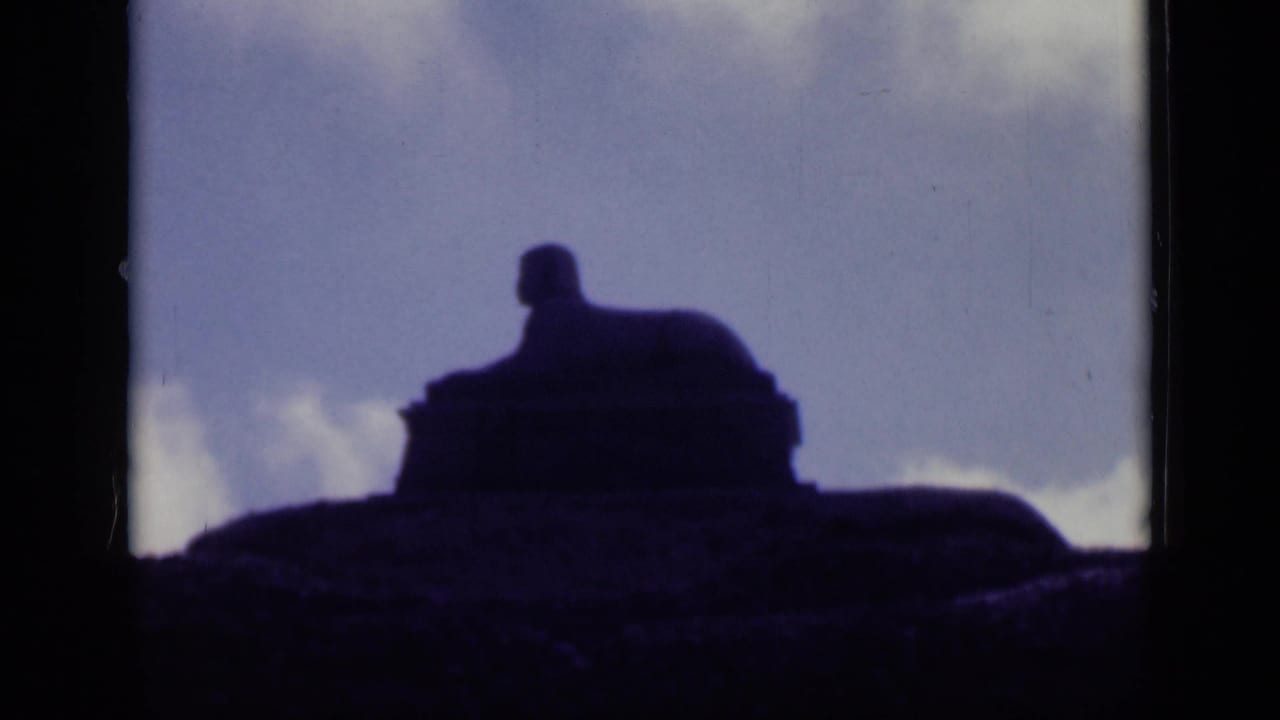 A final 1940s Cairo frame shows the statue-like silhouette centered against a cloudy sky with strong contrast and grain.