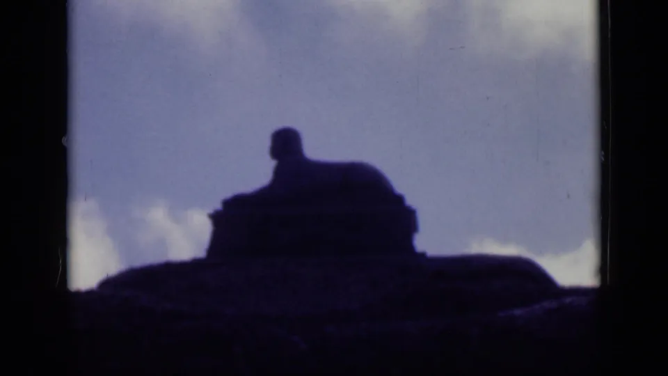 A final 1940s Cairo frame shows the statue-like silhouette centered against a cloudy sky with strong contrast and grain.