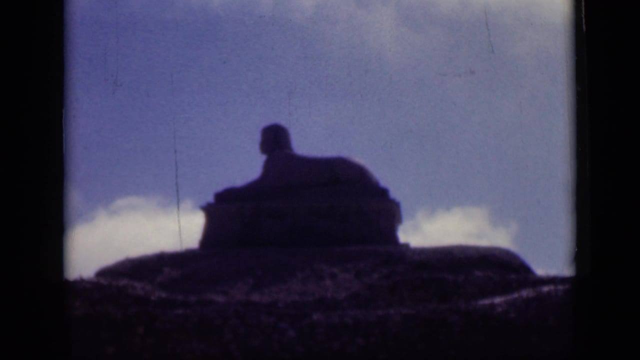 1946 Cairo home-movie frame showing the Sphinx in dark silhouette against sky, with visible 8mm frame edges.
