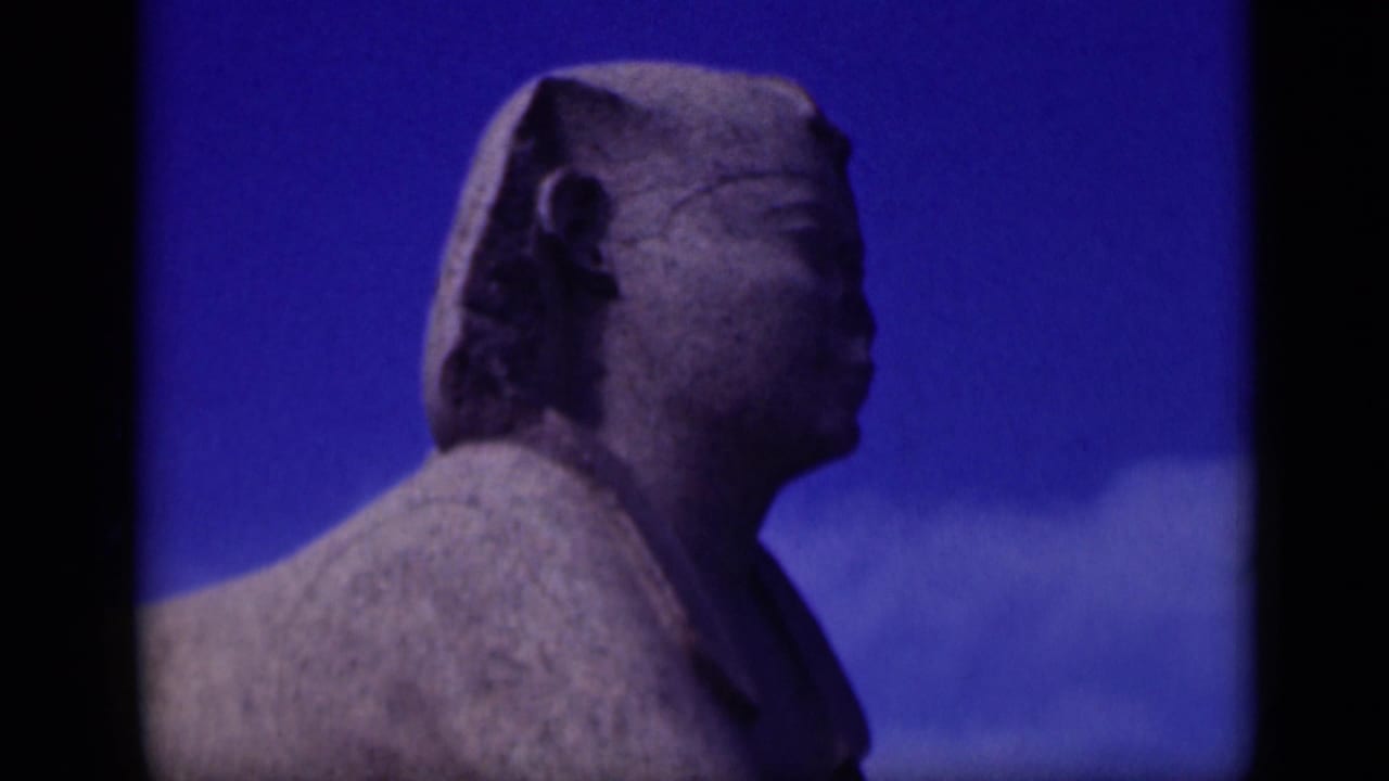 1946 Giza frame showing the Great Sphinx in side profile, with weathered stone texture and deep blue sky in the background.