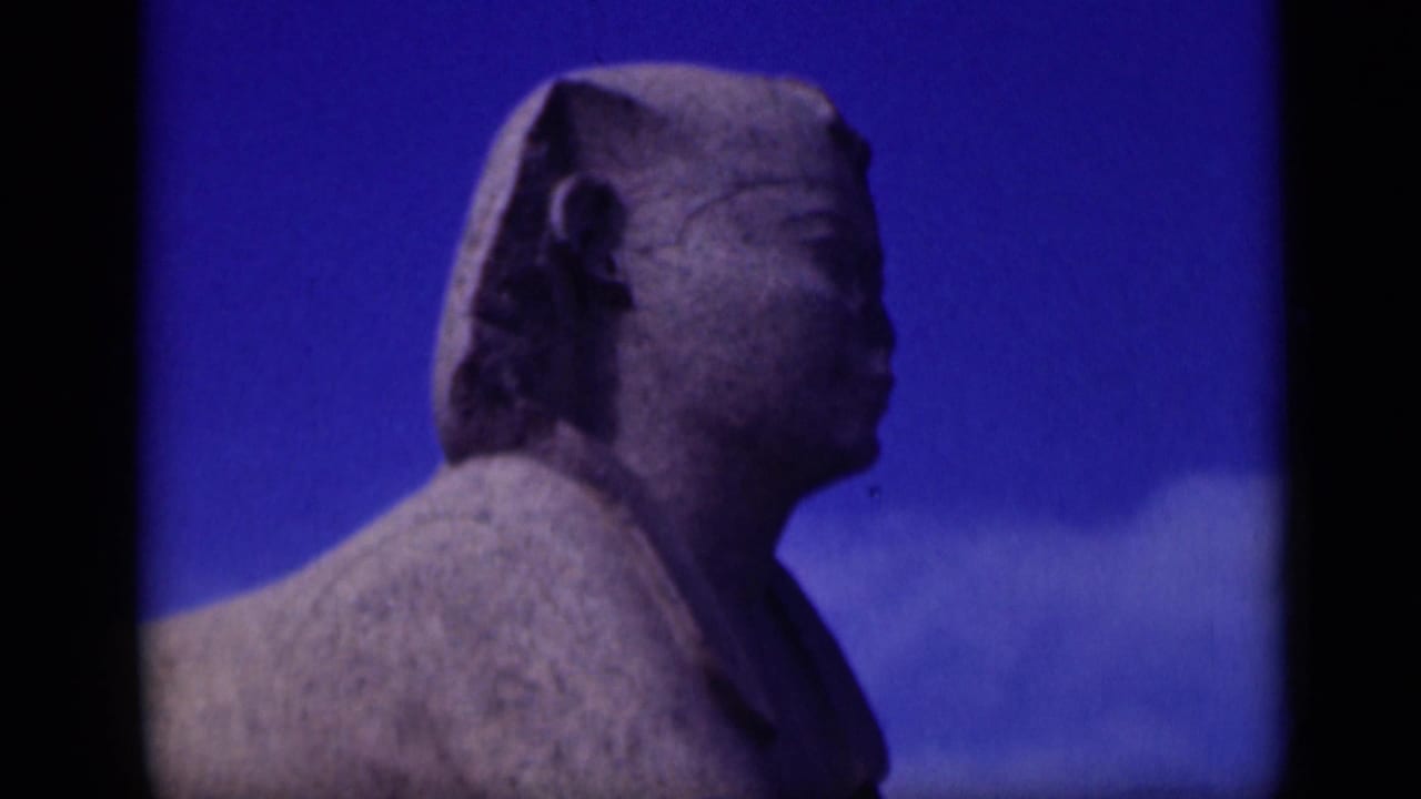 1946 Cairo home-movie frame showing a close side profile of the Sphinx with weathered stone texture and blue sky.