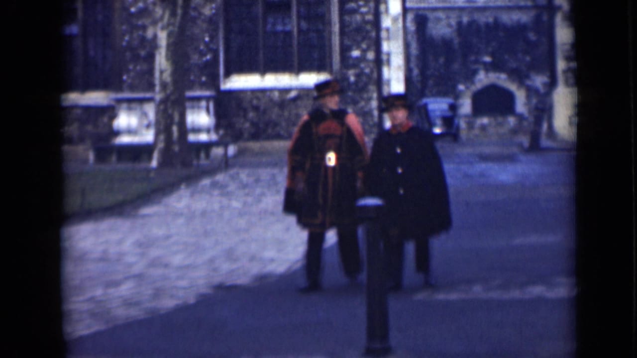 The London street scene shows the uniformed man and a second man in a dark coat moving closer, with stone walls and windows behind them.