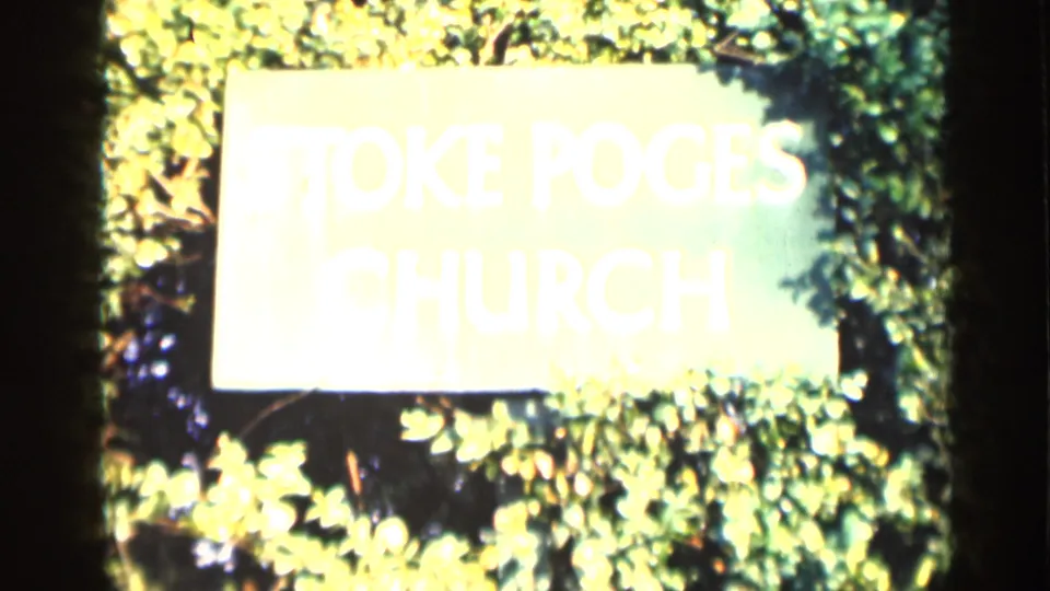 8mm frame showing a bright, overexposed Stoke Poges Church sign surrounded by dense green foliage.