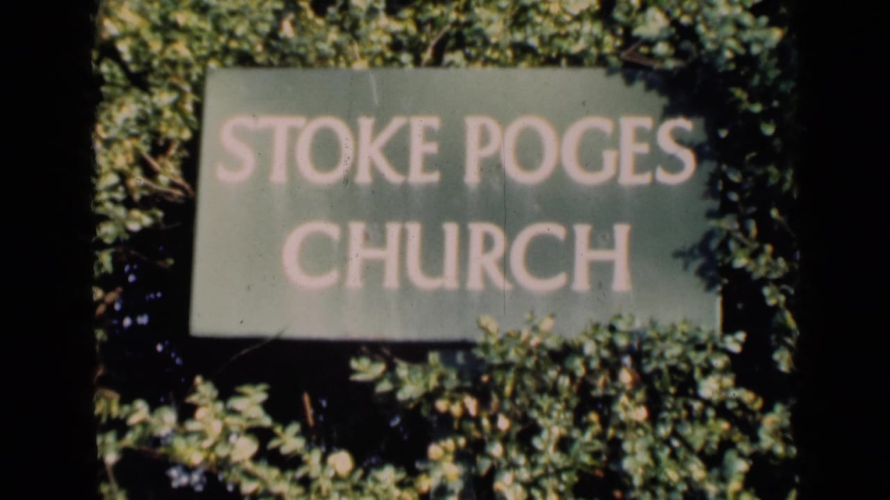 A soft 8mm frame of a Stoke Poges Church sign surrounded by dense greenery, from footage metadata dated 1946 in England.