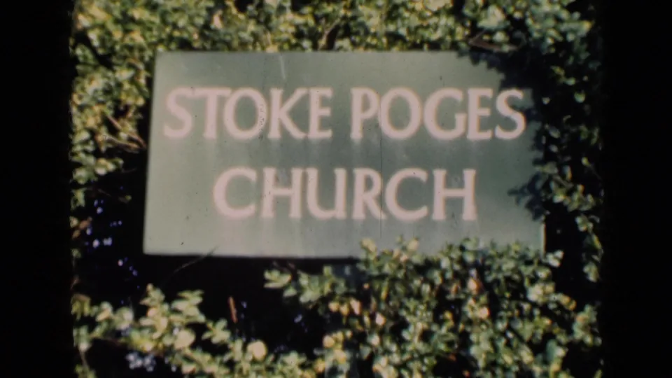 A soft 8mm frame of a Stoke Poges Church sign surrounded by dense greenery, from footage metadata dated 1946 in England.