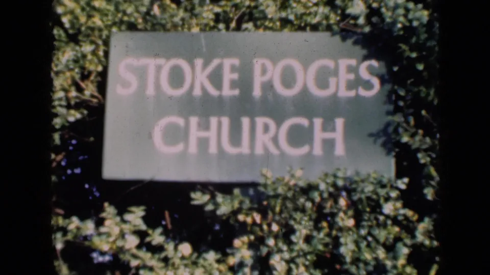 The church sign remains centered, with pale lettering and leaves encroaching on the frame in soft-focus 8mm footage.