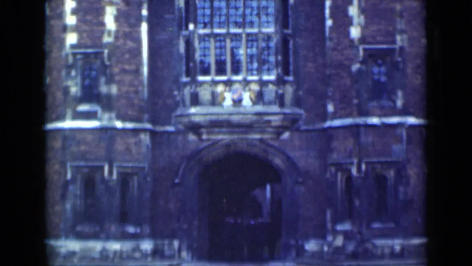 1946 London exterior view of a historic masonry building with a large archway, multi-pane window, and dark doorway.