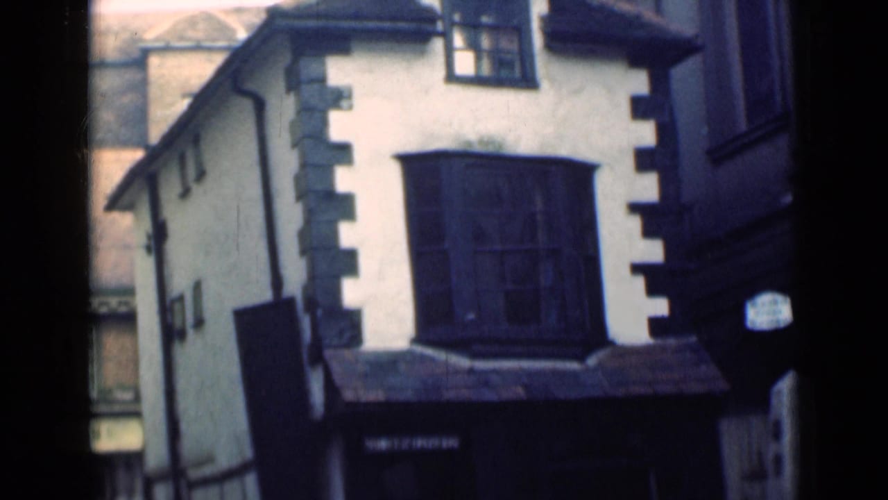 London 1946 exterior view of a white historic building with dark quoins and a prominent bay window.