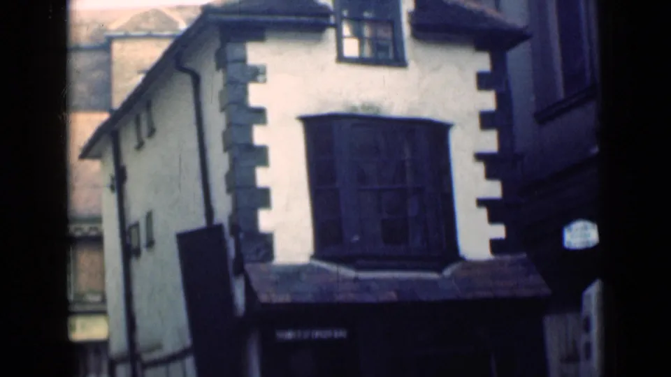 London 1946 exterior view of a white historic building with dark quoins and a prominent bay window.