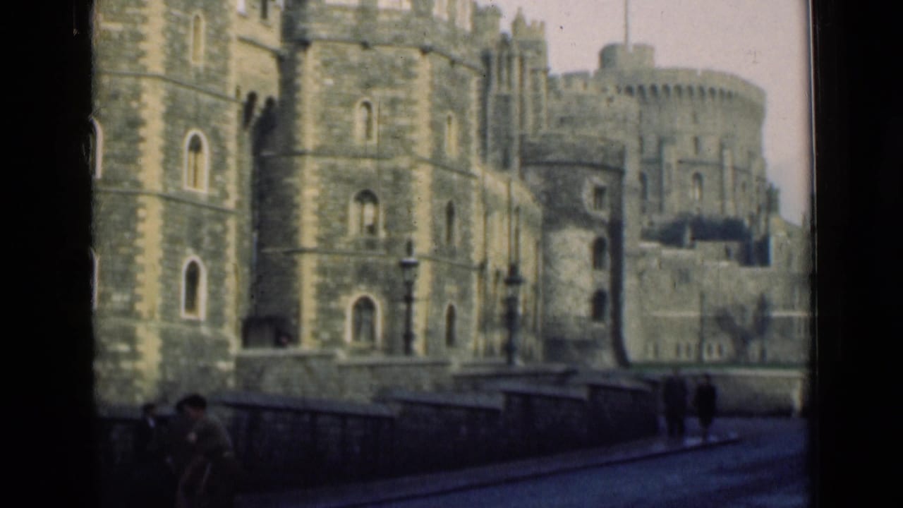 1946 home-movie view of Windsor Castle from across a street, with pedestrians near the stone wall and soft 8mm color.