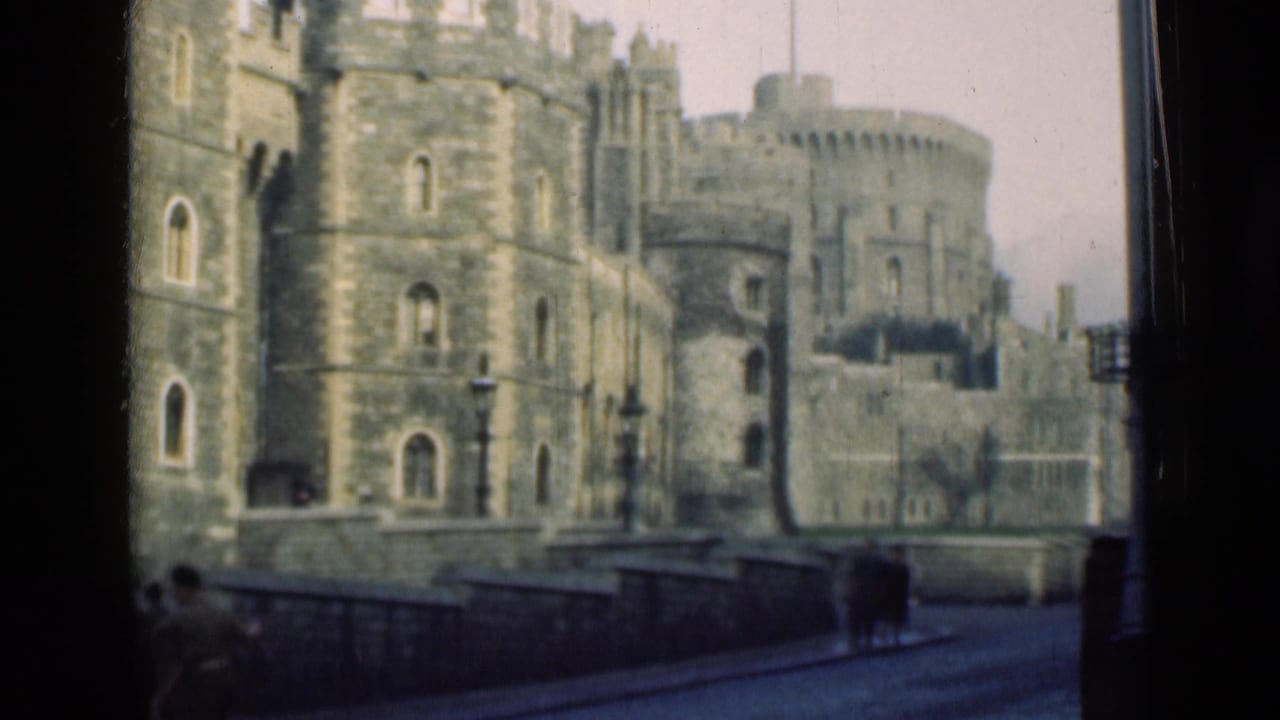 Windsor Castle exterior appears through the film frame, with distant pedestrians walking along the street in 1946 footage.