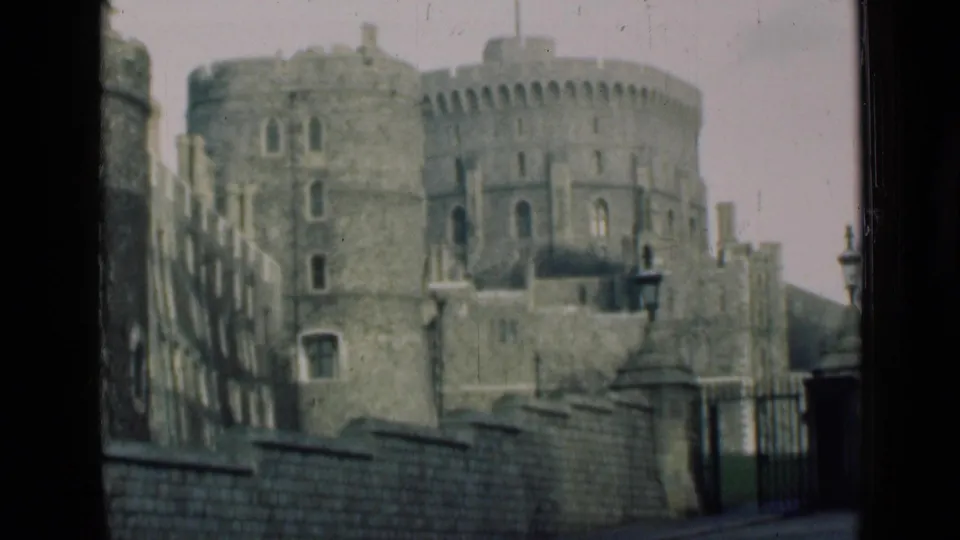 1946 8mm view of a round stone castle keep and battlements, seen from a visitor's exterior vantage in England.