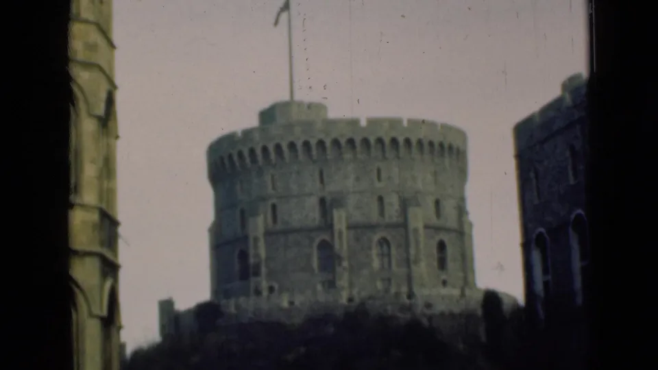 1946 8mm view of a round Windsor Castle turret framed by dark foreground architecture and pale sky.
