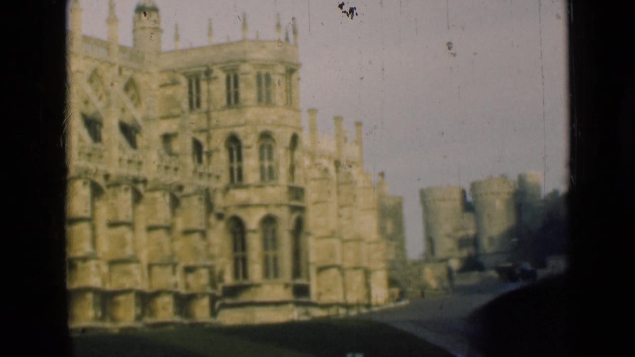 1946 London-area home-movie view of a Gothic stone castle facade and nearby roadway, framed by dark 8mm film borders.