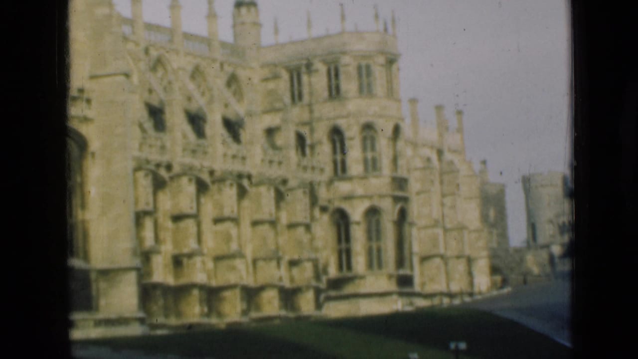 1946 London-area home-movie frame showing a pale Gothic stone exterior with arched windows, tracery, and a strip of lawn.