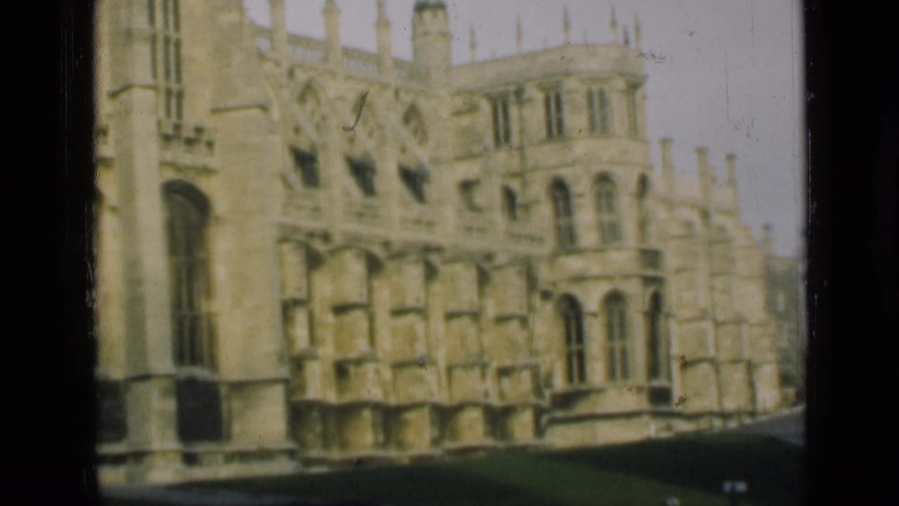 Gothic stone building exterior with ornate windows and a dark walkway edge.