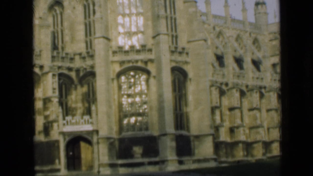 Gothic stone wall with arched windows and ornate carved architectural details.