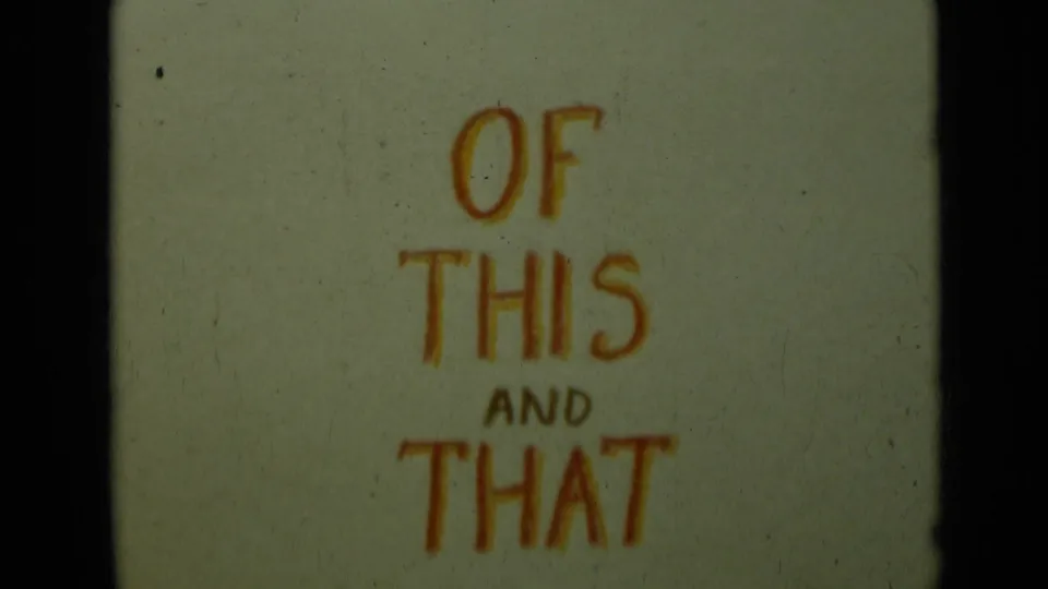 1949 8mm home-movie title card with orange handwritten text reading OF THIS AND THAT on yellowed film stock.
