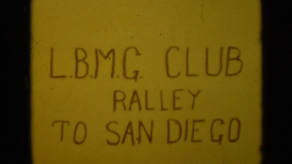 1949 8mm title card with dark handwritten text reading L.B.M.G. CLUB RALLEY TO SAN DIEGO.