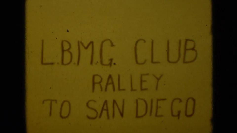 Final visible 1949 8mm title frame showing L.B.M.G. CLUB RALLEY TO SAN DIEGO in dark handwritten lettering.