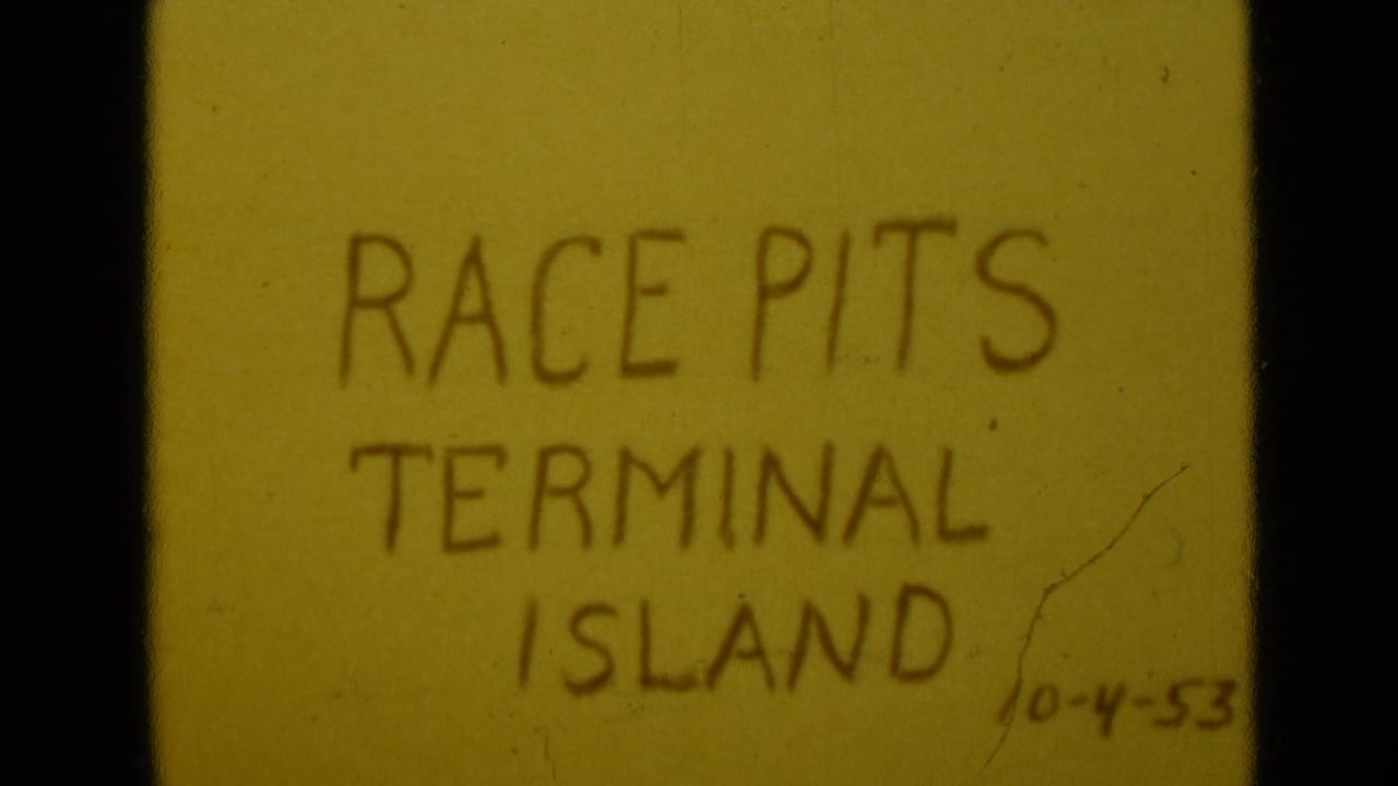 8mm frame of a yellow title card reading Race Pits Terminal Island, with a handwritten 10-4-53 date visible near the lower right.