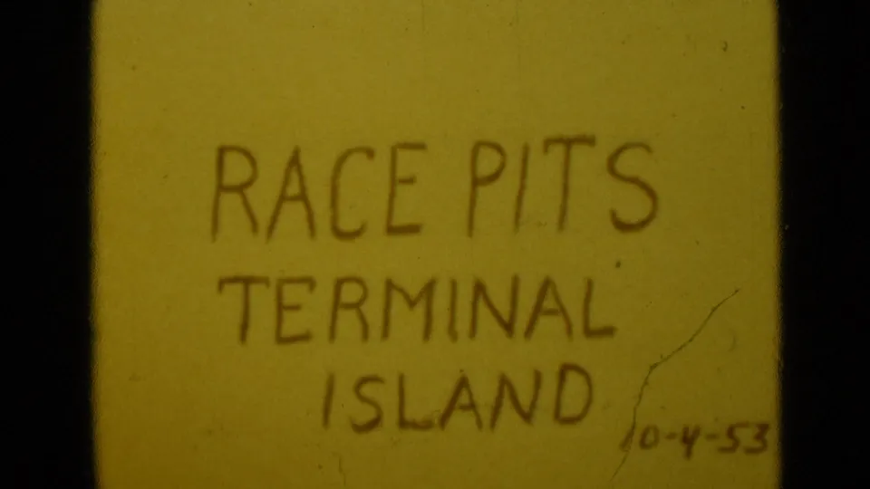 8mm frame of a yellow title card reading Race Pits Terminal Island, with a handwritten 10-4-53 date visible near the lower right.