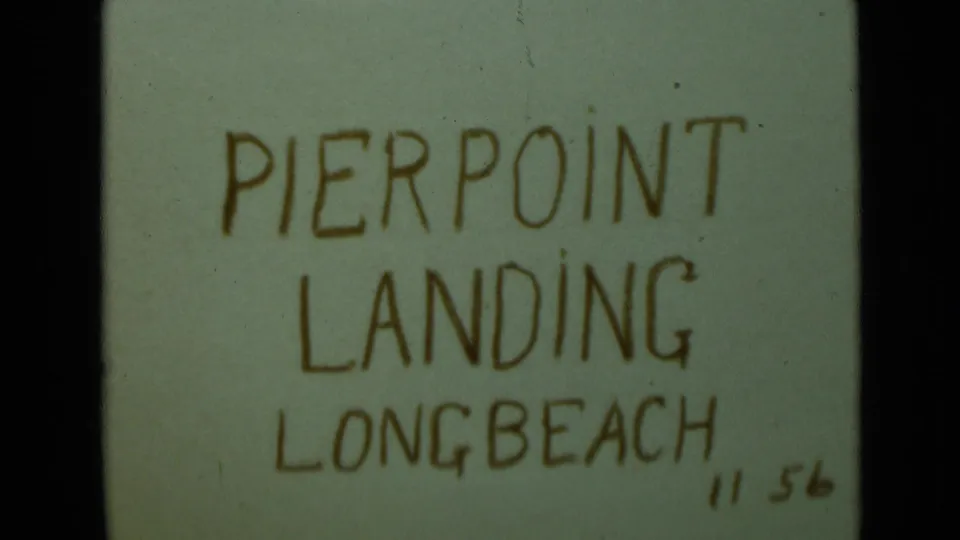 Repeated 8mm title card naming Pierpoint Landing, Long Beach, with soft focus, visible frame edges, and dust marks.