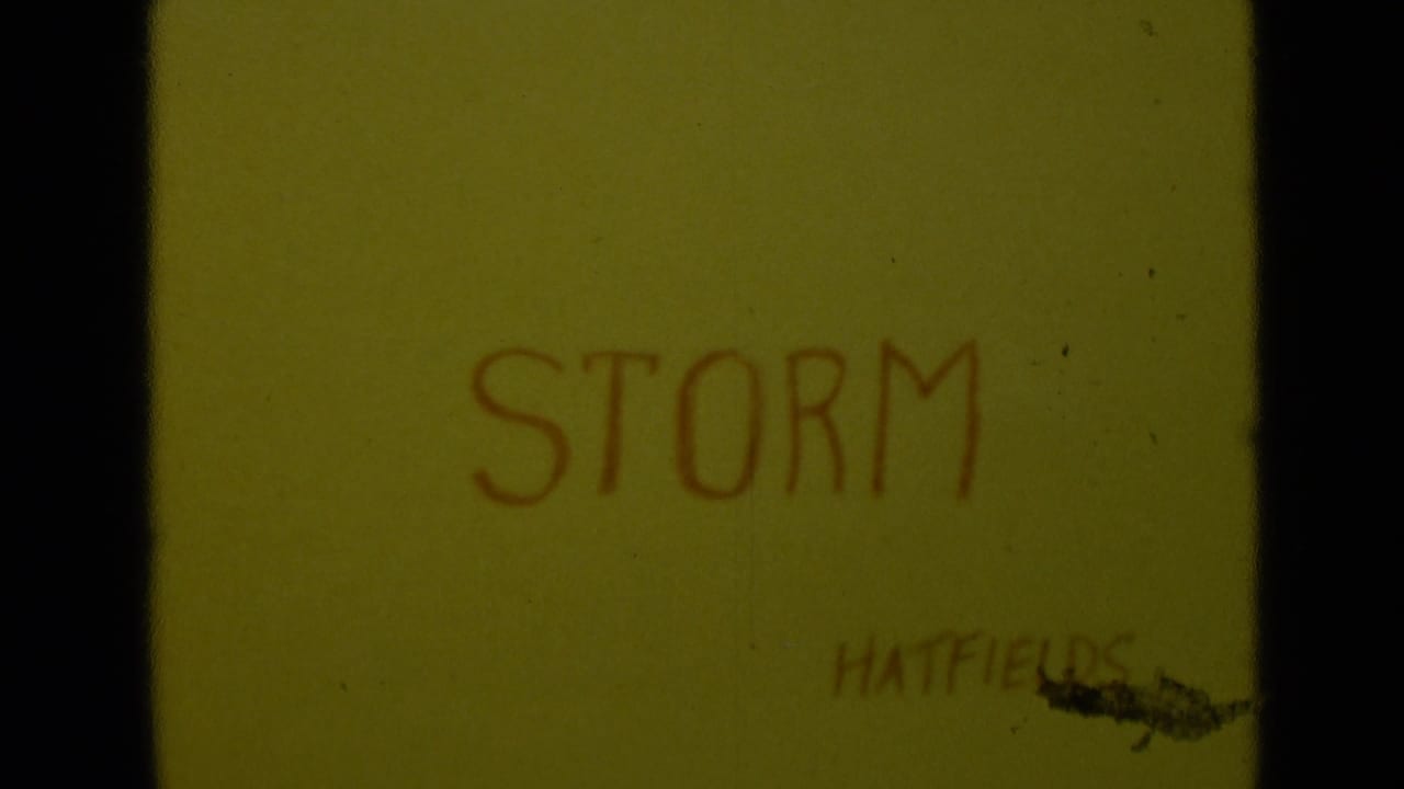 Yellow 8mm title card with STORM handwritten in red and the name HATFIELDS partly visible near the lower right.