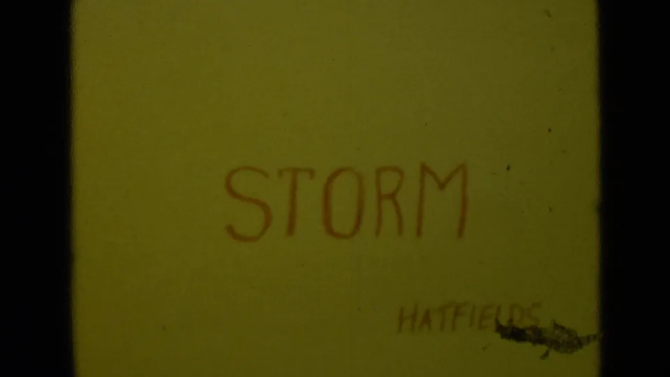 Yellow 8mm title card with STORM handwritten in red and the name HATFIELDS partly visible near the lower right.