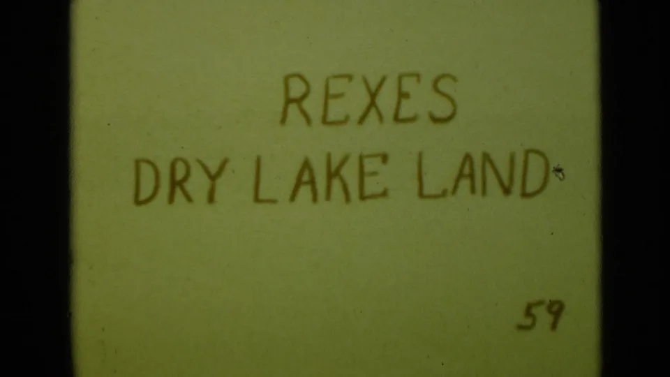 1949 8mm title card with handwritten text reading REXES DRY LAKE LAND, likely introducing a desert scene near San Diego.