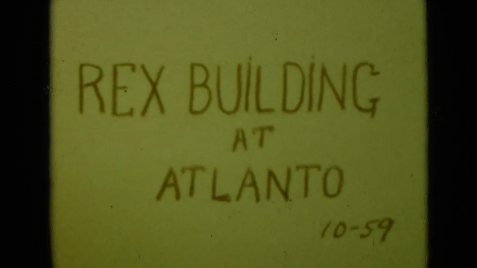 A steadier 8mm title-card frame shows the handwritten words Rex Building at Atlanto, with the date 10-59 near the lower right.