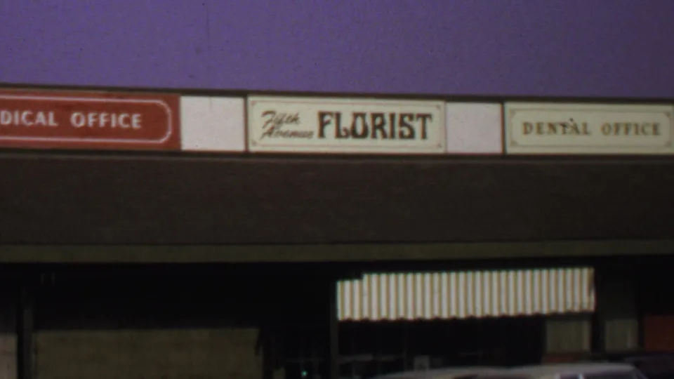 Closer 1969 Washington DC view of Fifth Avenue Florist signage beside medical and dental office signs.