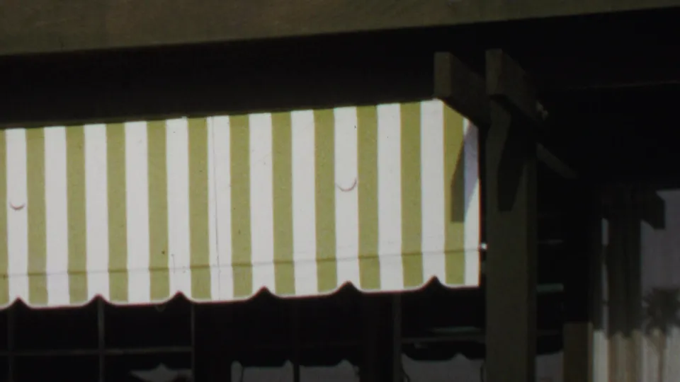 Striped awning and shaded storefront detail from the Washington, DC shop scene.