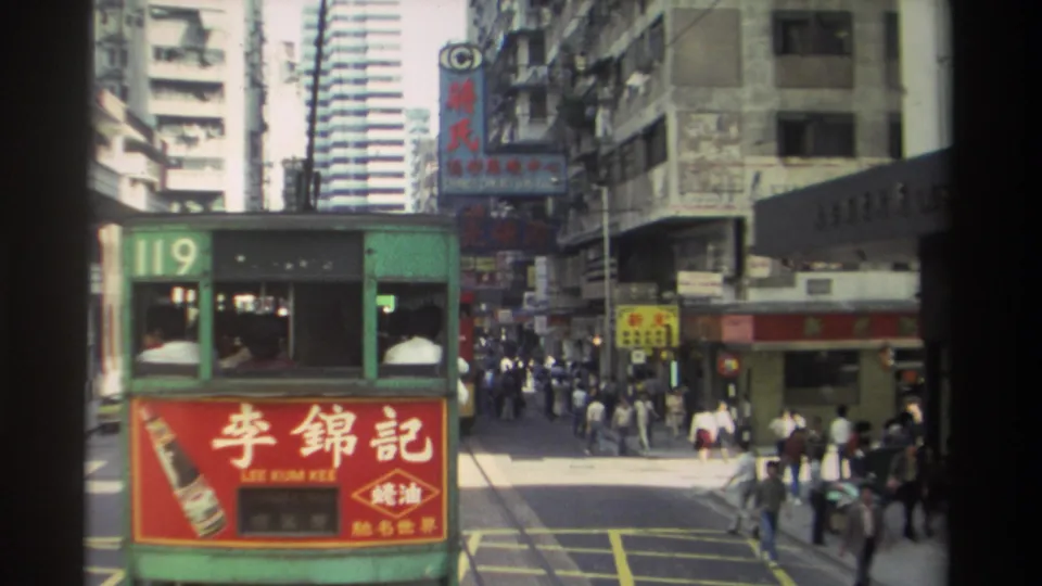 1982 Hong Kong tram scene with the 119 car close to camera, Lee Kum Kee ad panel, pedestrians, street markings, and vertical Chinese signs.