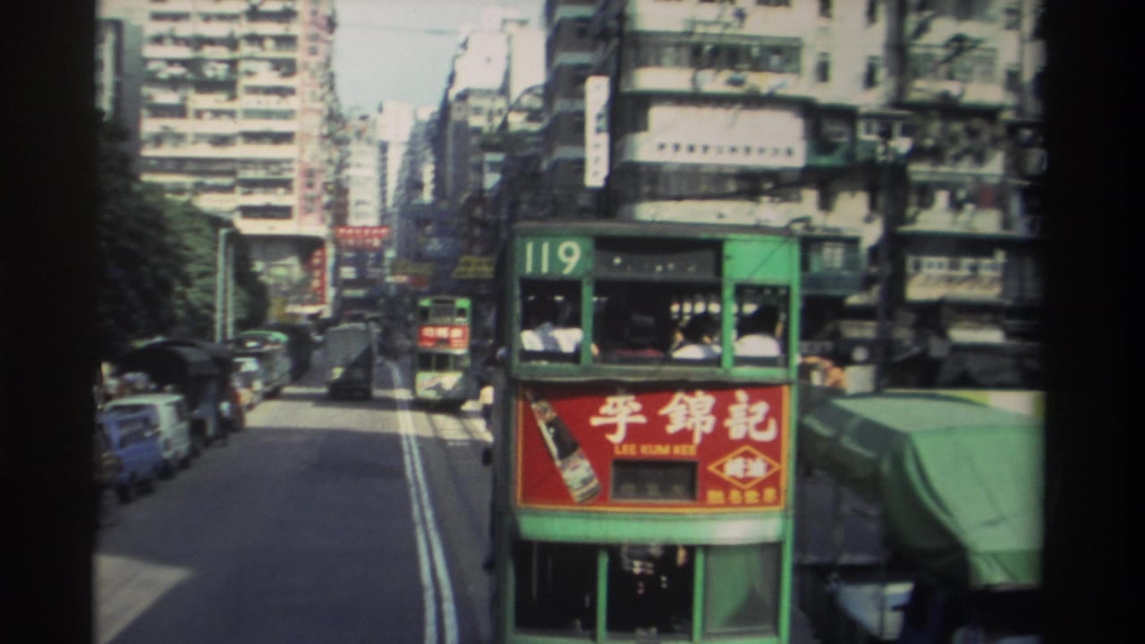 Rear of green double-decker tram route 119 with red Lee Kum Kee advertisement, Hong Kong street behind