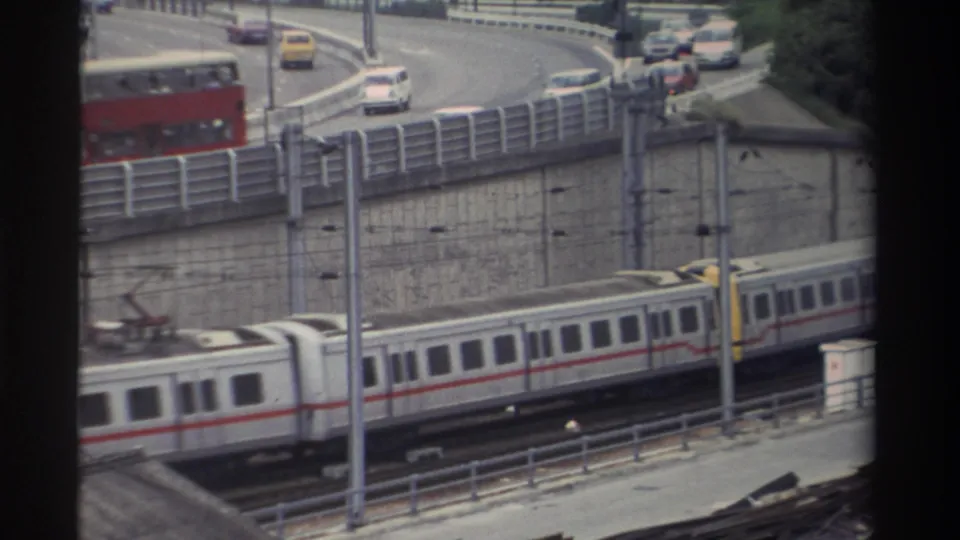 8mm frame from Taiwan, c.1982; train has moved right while the red double-decker bus occupies the centre of the curved elevated road.