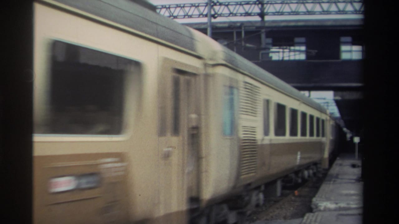 Passenger train passing through a covered station with pronounced motion blur, Taiwan, 1982, 8mm home movie.