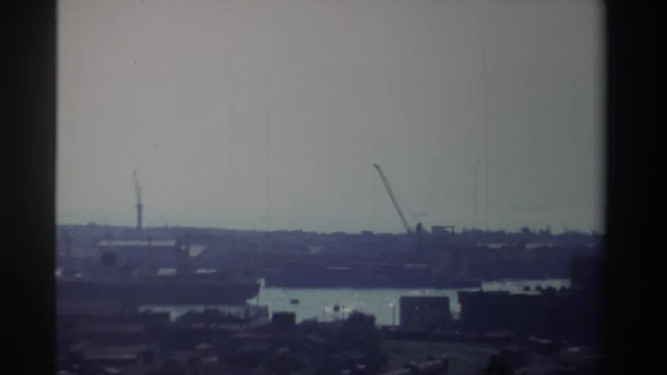 1982 Taiwan port view with cranes and waterfront structures seen through grainy, faded 8mm home-movie footage.