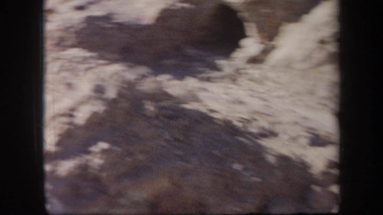 Blurred rocky terrain seen from a handheld 8mm frame.
