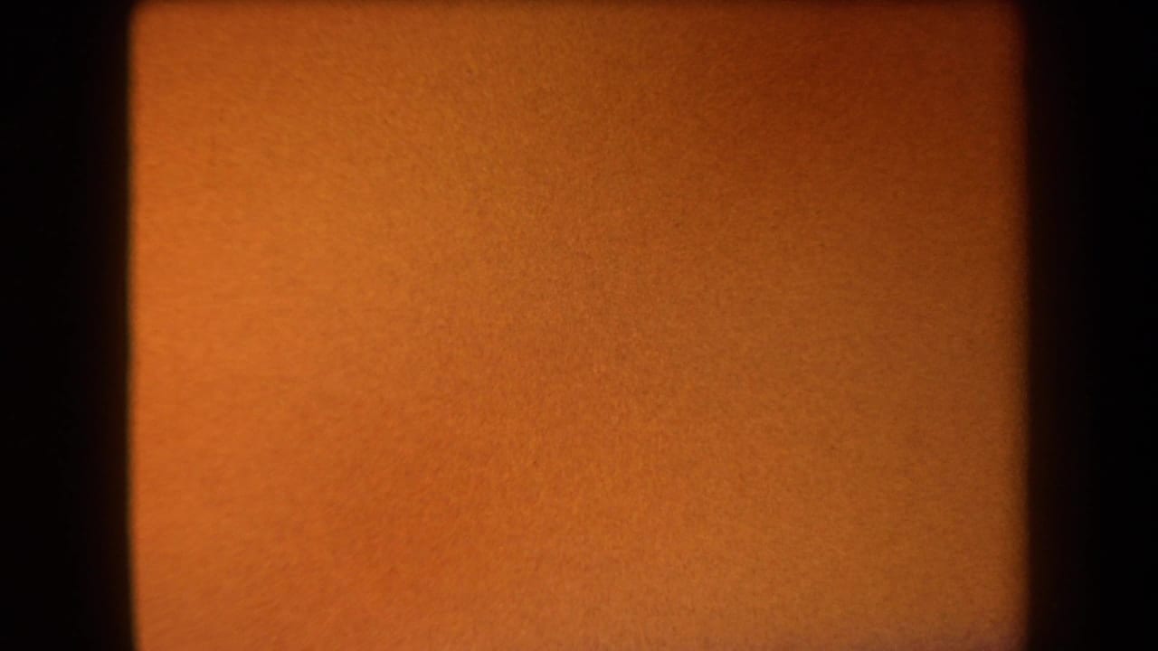 Soft orange 8mm frame with a dark vertical band at left and grain texture.