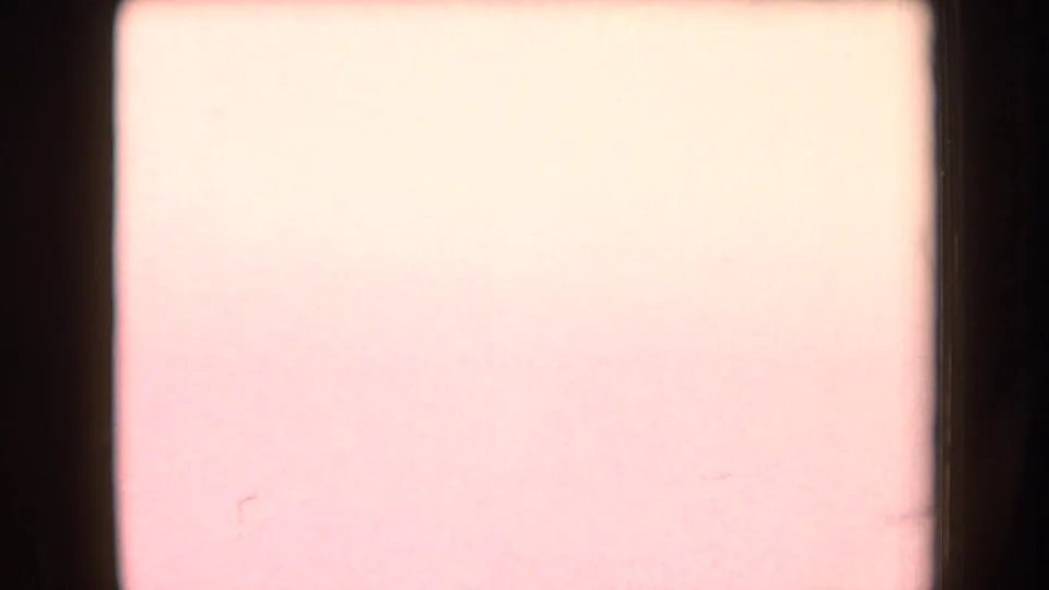 Overexposed 8mm frame from the Arizona clip with washed-out color and minimal scene detail.