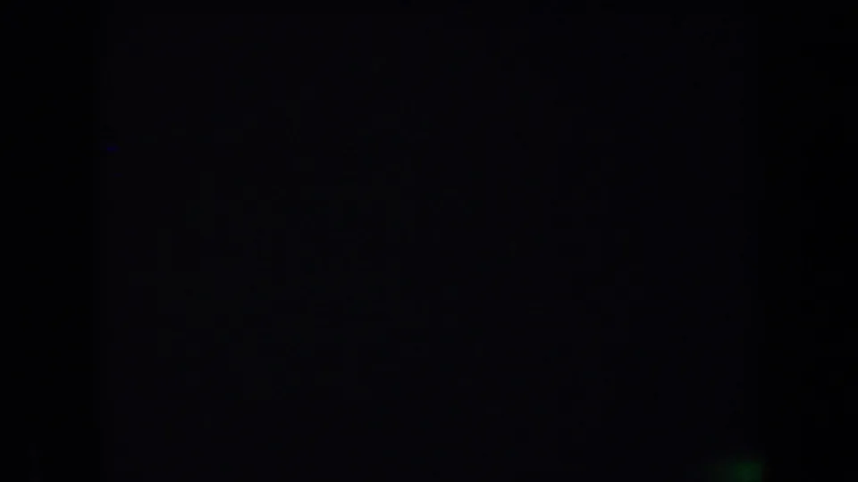 Final dark 8mm frame from the Arizona camping clip, with faint film color artifacts and no discernible subject visible.