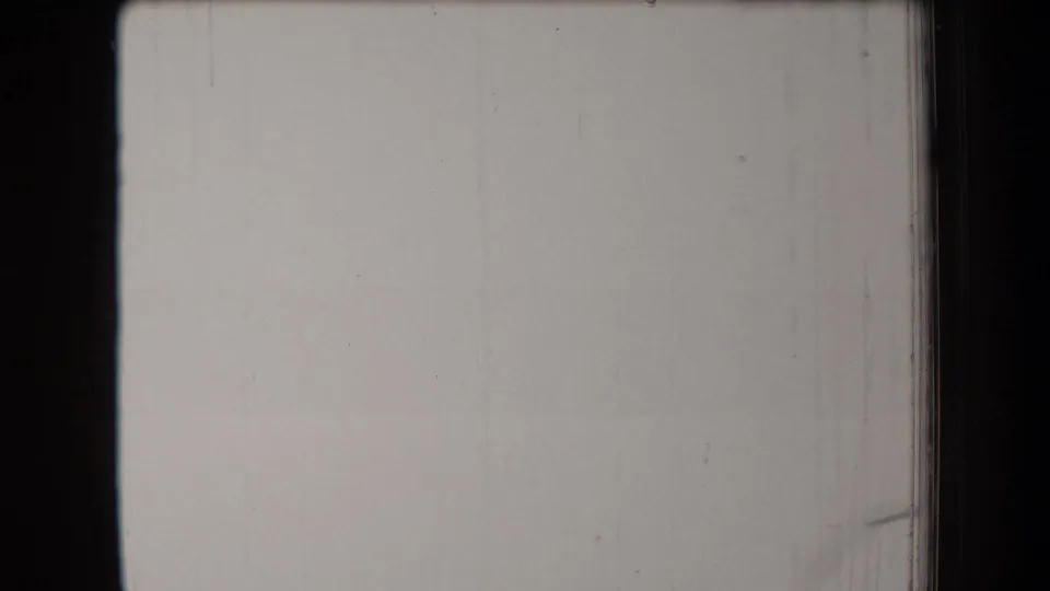1958 Arizona 8mm frame showing a mostly pale exposed area, black gate border, and subtle vertical film wear.