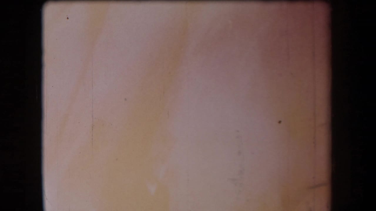 Faded 8mm frame from the 1958 Arizona clip, showing exposure wash, scratches, and no distinct people or setting detail.