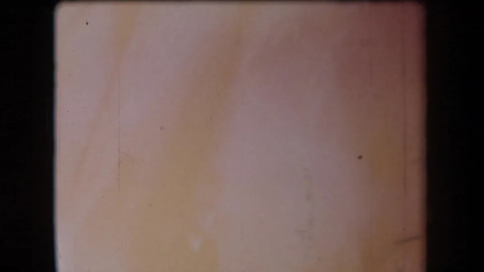 Faded 8mm frame from the 1958 Arizona clip, showing exposure wash, scratches, and no distinct people or setting detail.