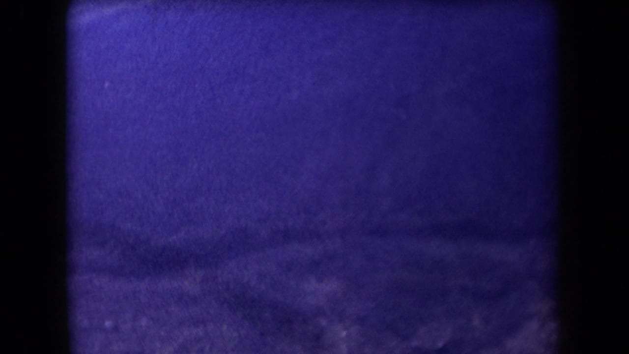 Dark purple landscape frame with hills and heavy film border shadowing.