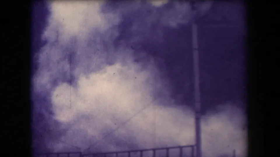 1958 Arizona 8mm view of pale steam or spray near a railing, with a vertical post and heavy purple film cast.